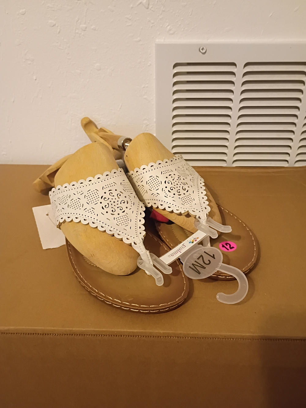 Palms laser-cut white thong sandals feature intricate floral detailing and are s